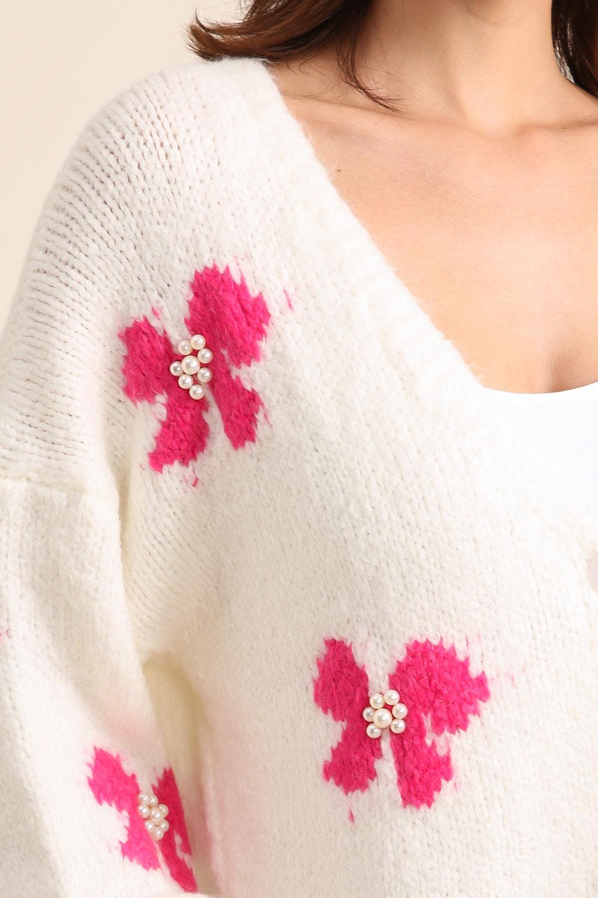Strickjacke mit Schmetterlingsmuster und Perlenbesatz Rosa